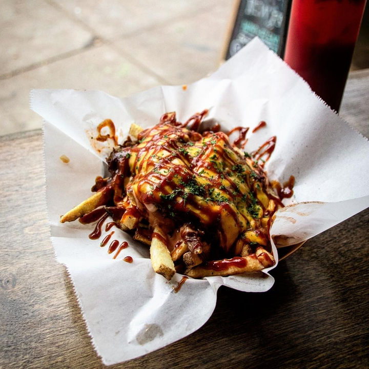 Urban Skillet loaded fries topped with sauce and chopped toppings
