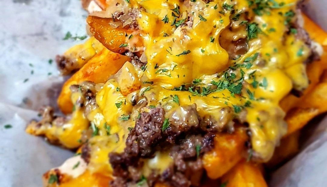 Loaded fries topped with seasoned beef, cheese, and sauce